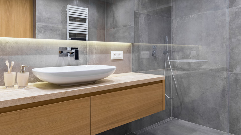 concrete shower with wooden vanity