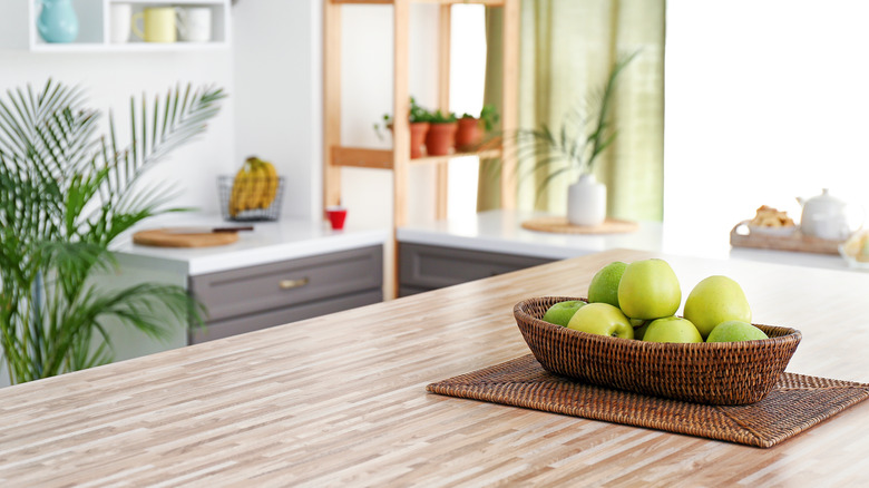 green apples in woven bowl