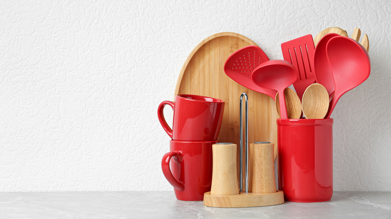 red utensil holder and mugs