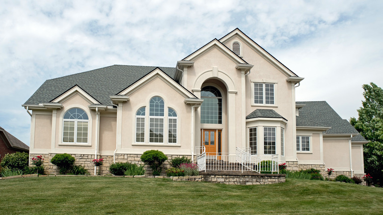 beige house with large windows 