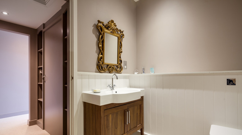 gilt mirror above sink