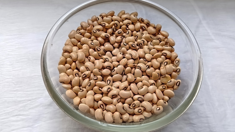 Tan dried beans in glass bowl
