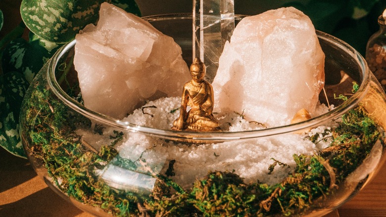 glass bowl with crystals, religious statue, and fake moss