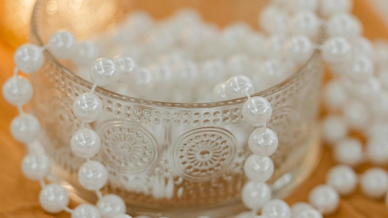 glass dish with beads coming out of it