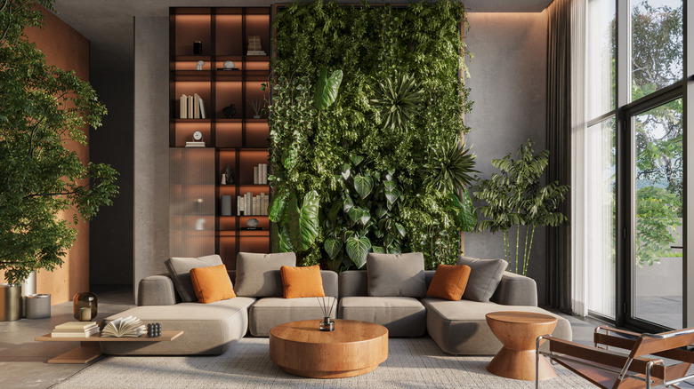 A living wall acts as a backdrop in an open plan living room with a contemporary design aesthetic.