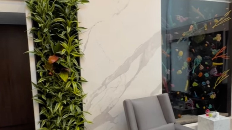 A living wall of Draceana plants adorns a living room wall in a home.