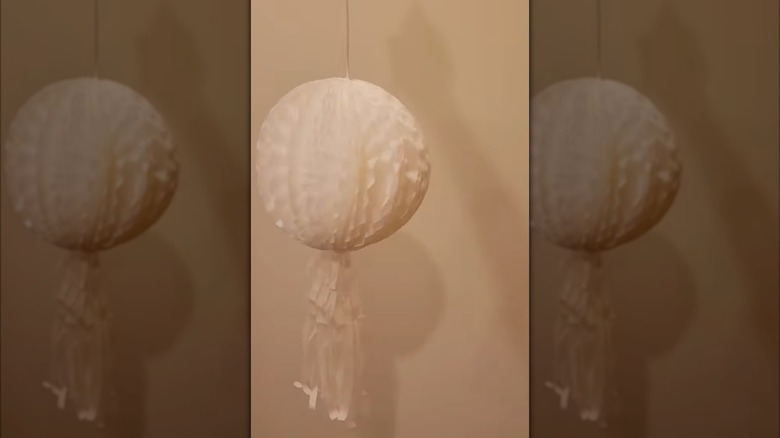 A hanging white decoration pom-pom.