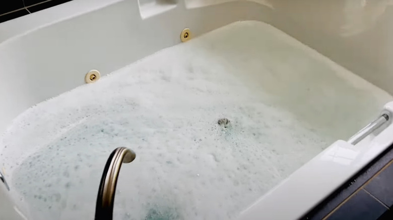 A filter bath bomb in a running bubble bath.
