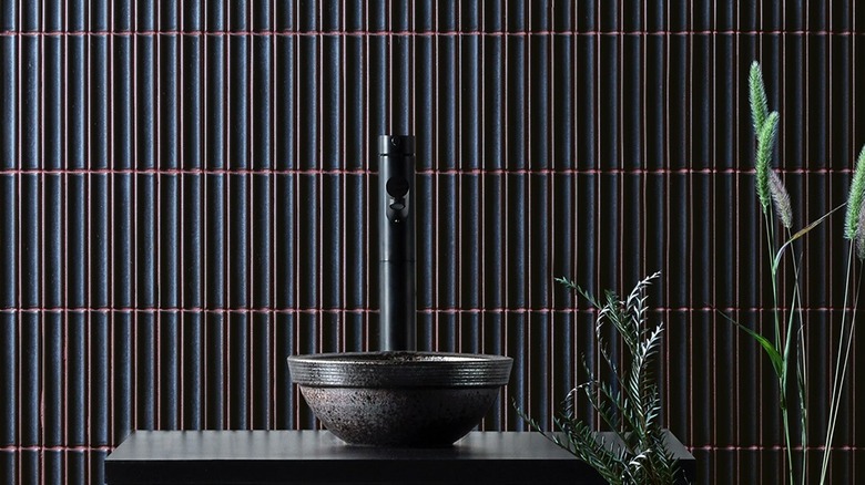 Bathroom with black tile and pink grout
