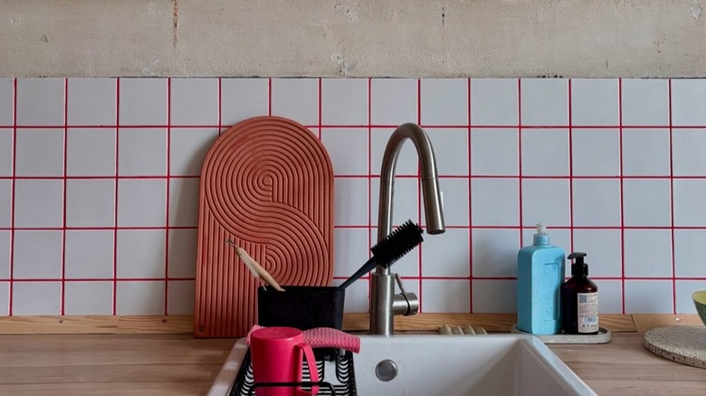 Kitchen with white tile and pink grout