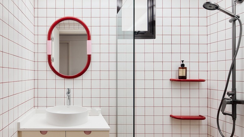 Bathroom with white tile and red grout