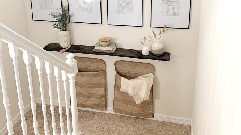 Floating shelf and hampers on a staircase landing