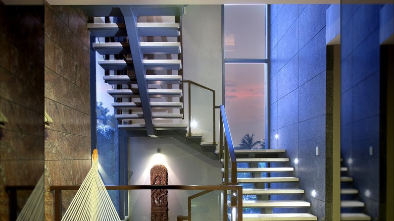 A slim floor to ceiling window on a staircase landing