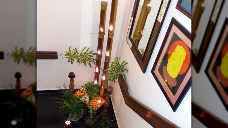 Bamboo lights, decorative table, and plants on staircase landing
