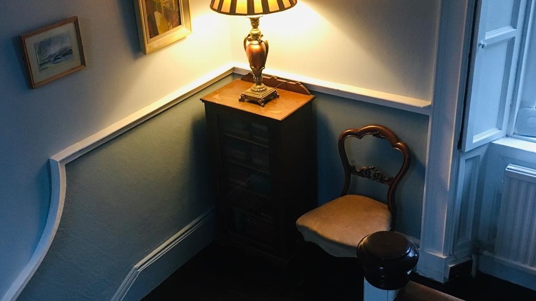 A chair and lamp on a staircase landing