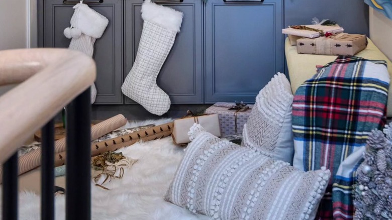 Rugs, blankets, and pillows on a staircase landing