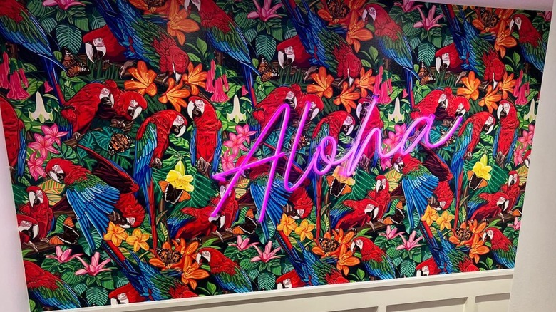 Bold mural and neon sign on a staircase landing
