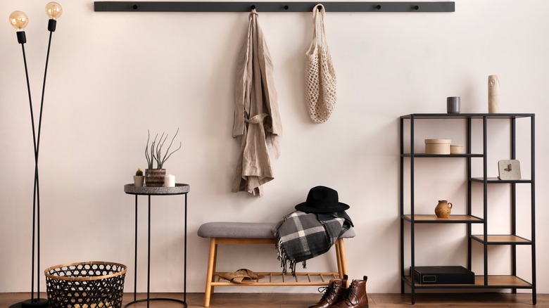 bench below hanging coat rack