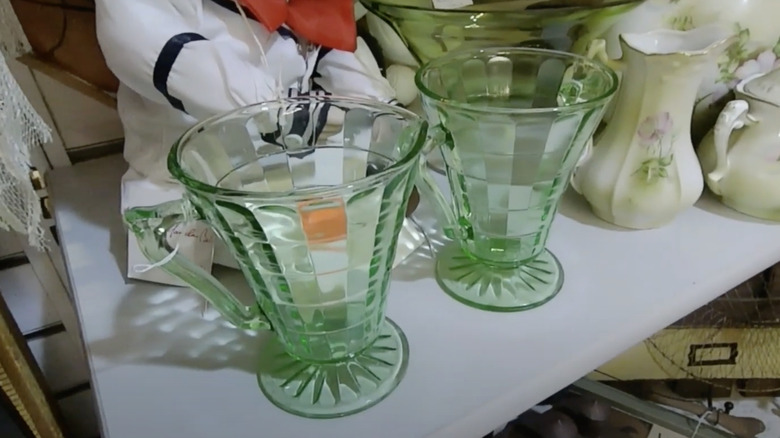 Two glasses in the Block Optic pattern by Hocking Glass Company sit on a thrift store shelf