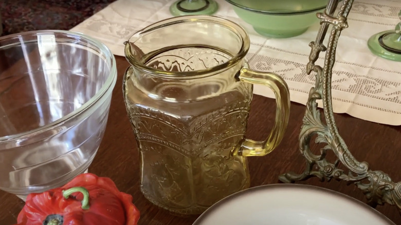 A cup with the Patrician or Spoke pattern by Federal Glass Company sits on a tabletop.