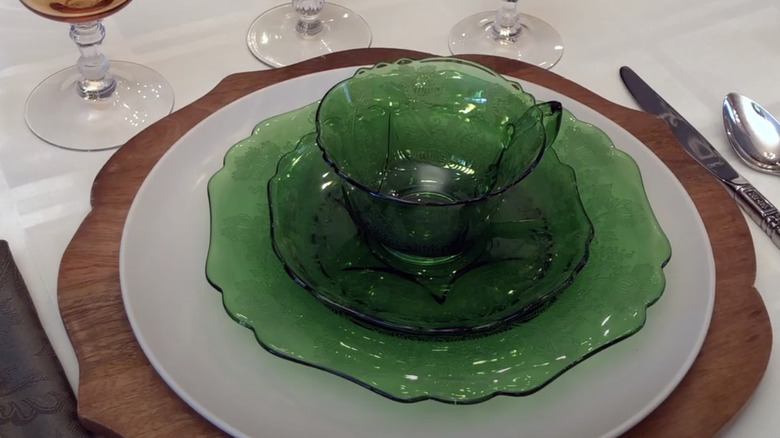 A table set with a plate and saucer grouping in the green pattern Gloria by Cambridge Glass Co.