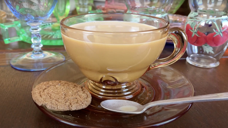 An amber teacup and saucer by New Martinsville Glass Co. in a pattern called Moondrops.