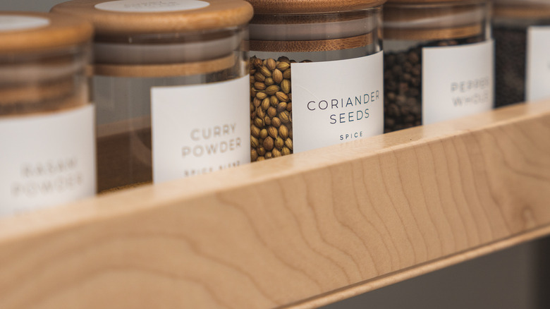 glass jars on wooden shelf