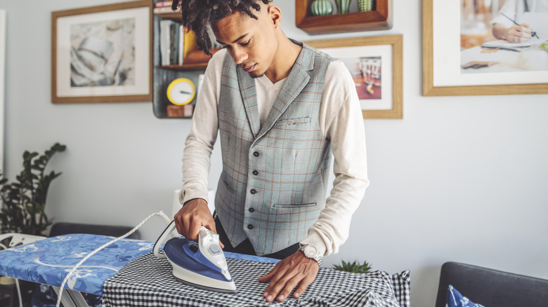 Man ironing clothes