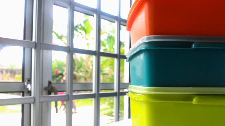 Tupperware containers by a window
