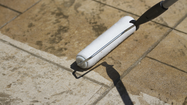 Rolling sealant onto a concrete surface