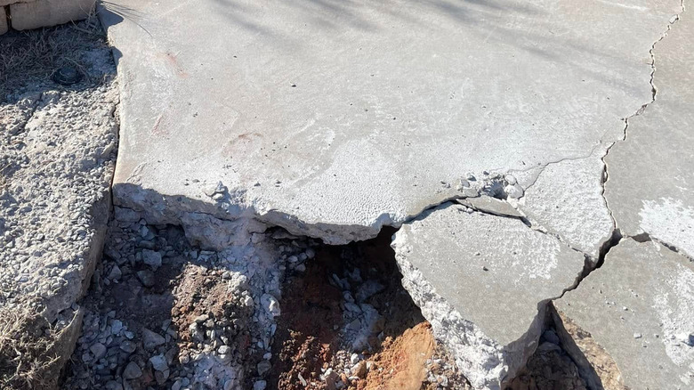 Water damage from water under a concrete driveway