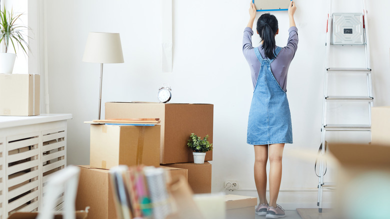 woman hanging art