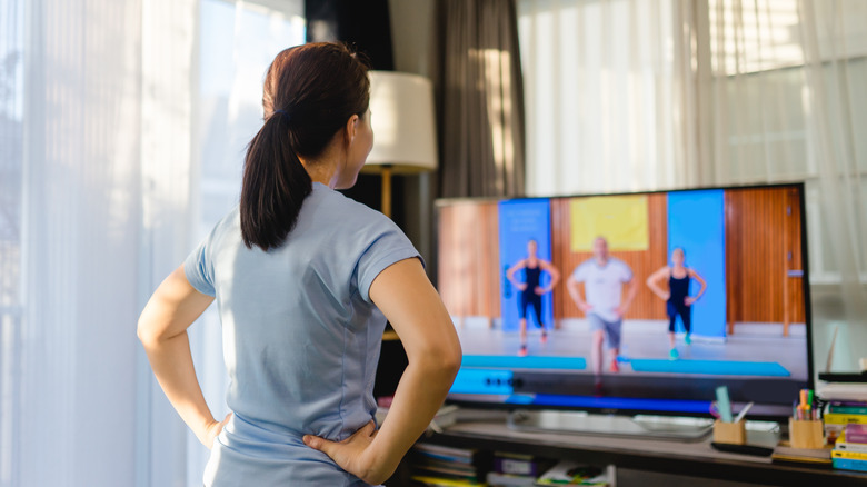woman follows home exercise video