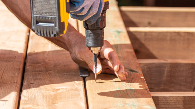 worker drilling boards