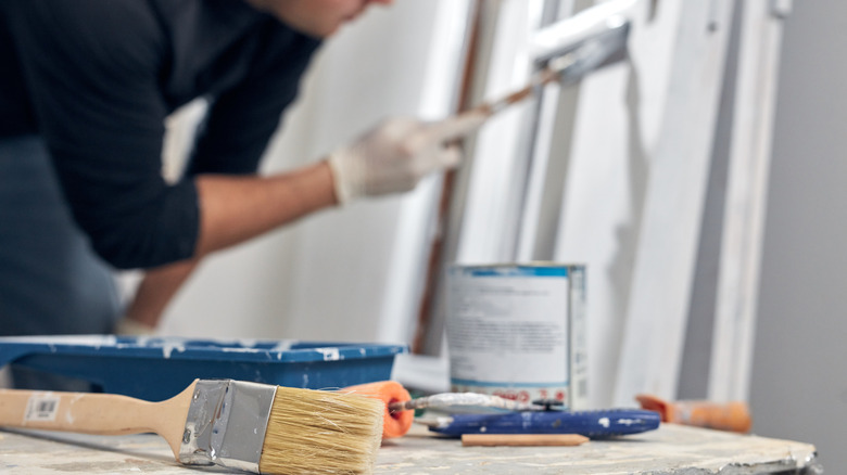 person painting interior white