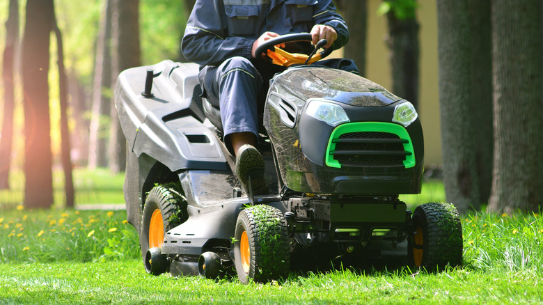 man driving mower