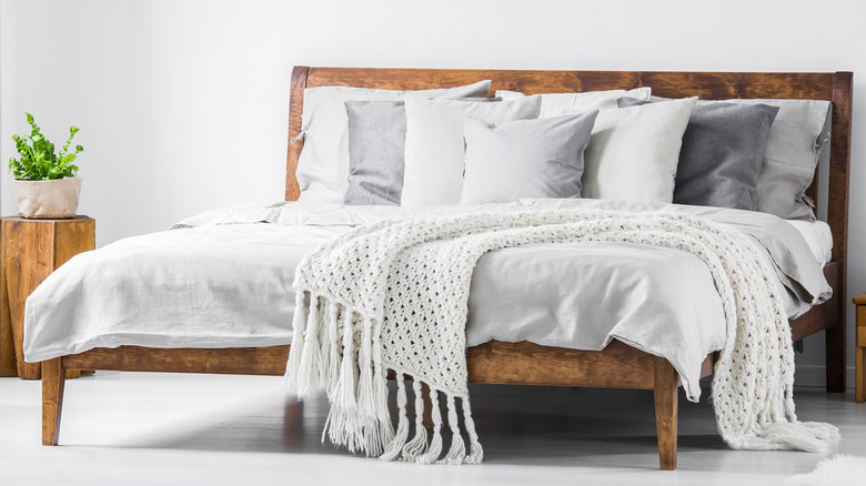 Wood bed with white bedding