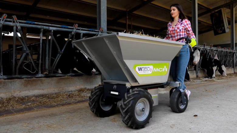 woman pushing an electric motorized wheelbarrow