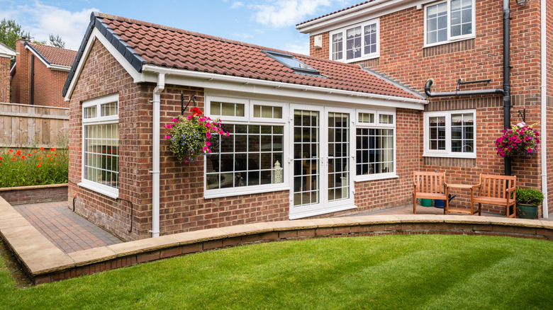 brick sunroom with brick patio