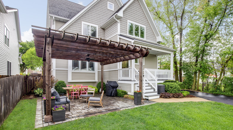 wooden gazebo over brick patio