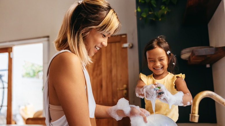 Mom and daughter washing dishes