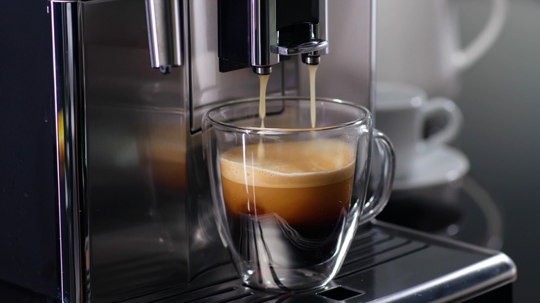 filled coffee mug on machine