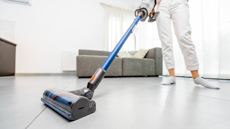 person vacuuming floor