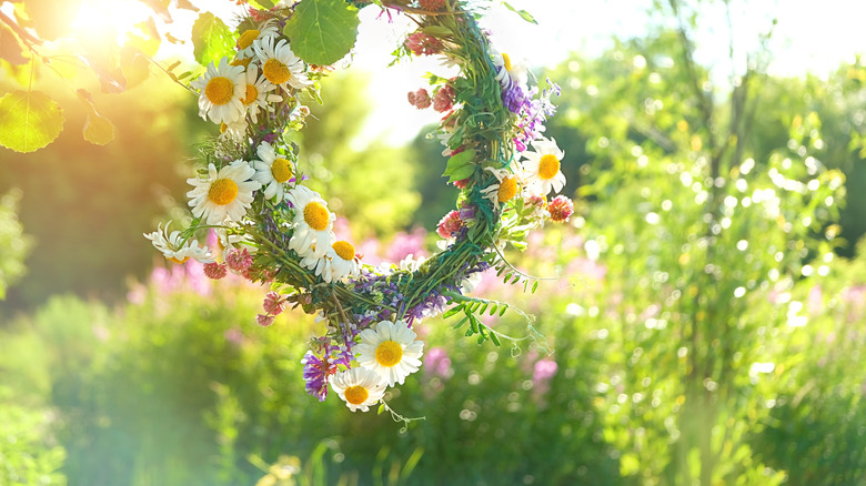 Floral wreath hanging in meadow 