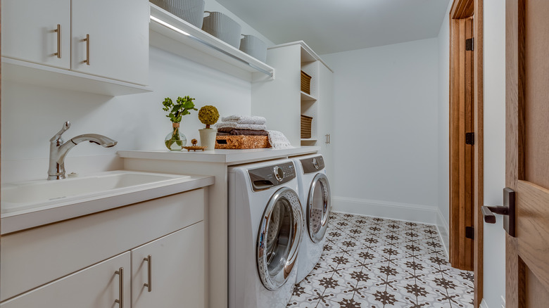 Laundry room with baskets and a pattern tile floor