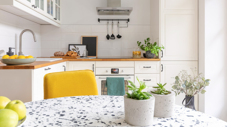 white kitchen with yellow chair