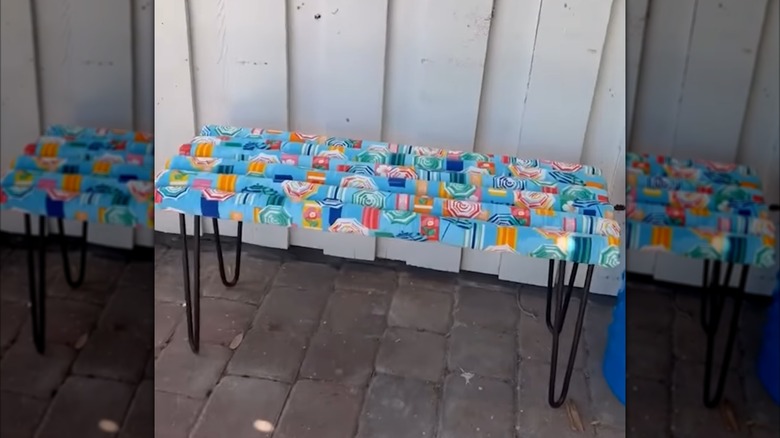 A pool noodle bench with a fun fabric covering.