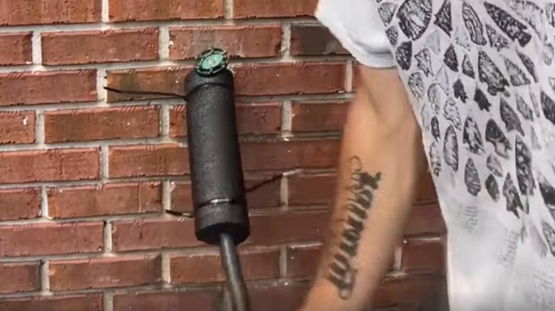 Black pool noodle on water hose.