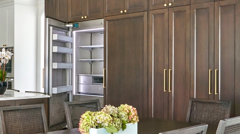 A kitchen with a built-in cabinet refrigerator.