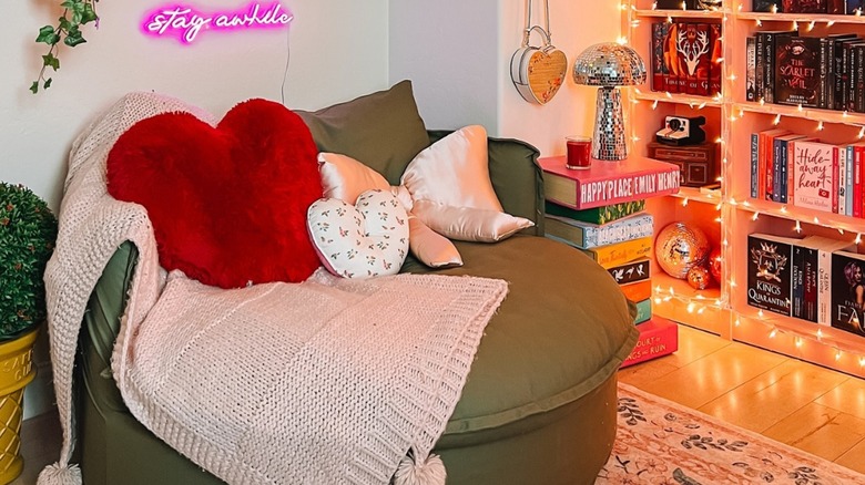 A green over-sized couch in reading nook.